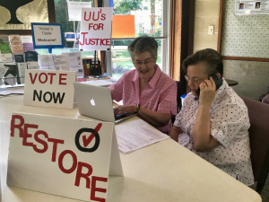 two women making telephone calls to encourage voter registration